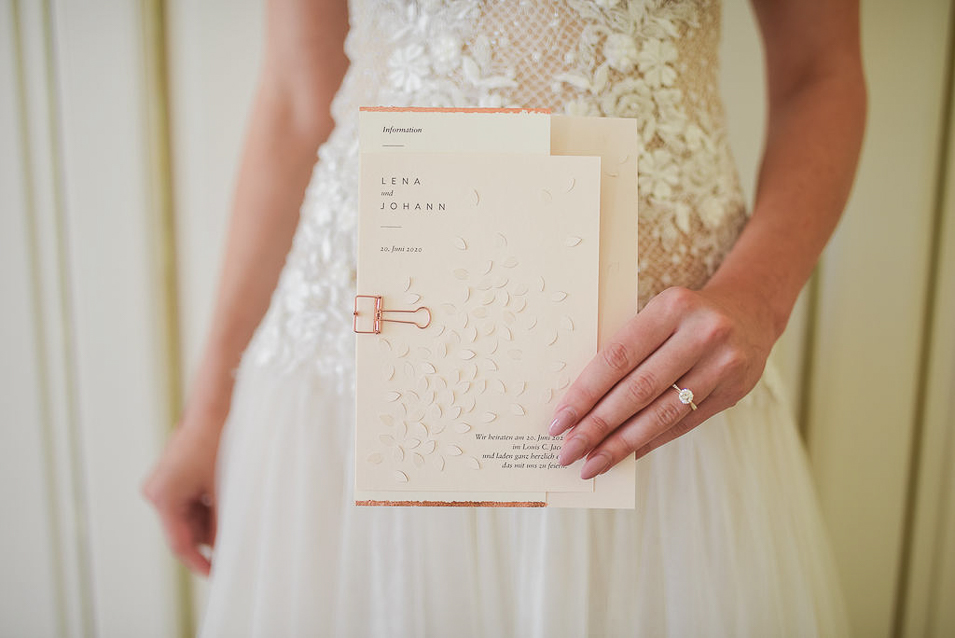 Braut aus Hamburg hält Einladungskarte zur Hochzeit